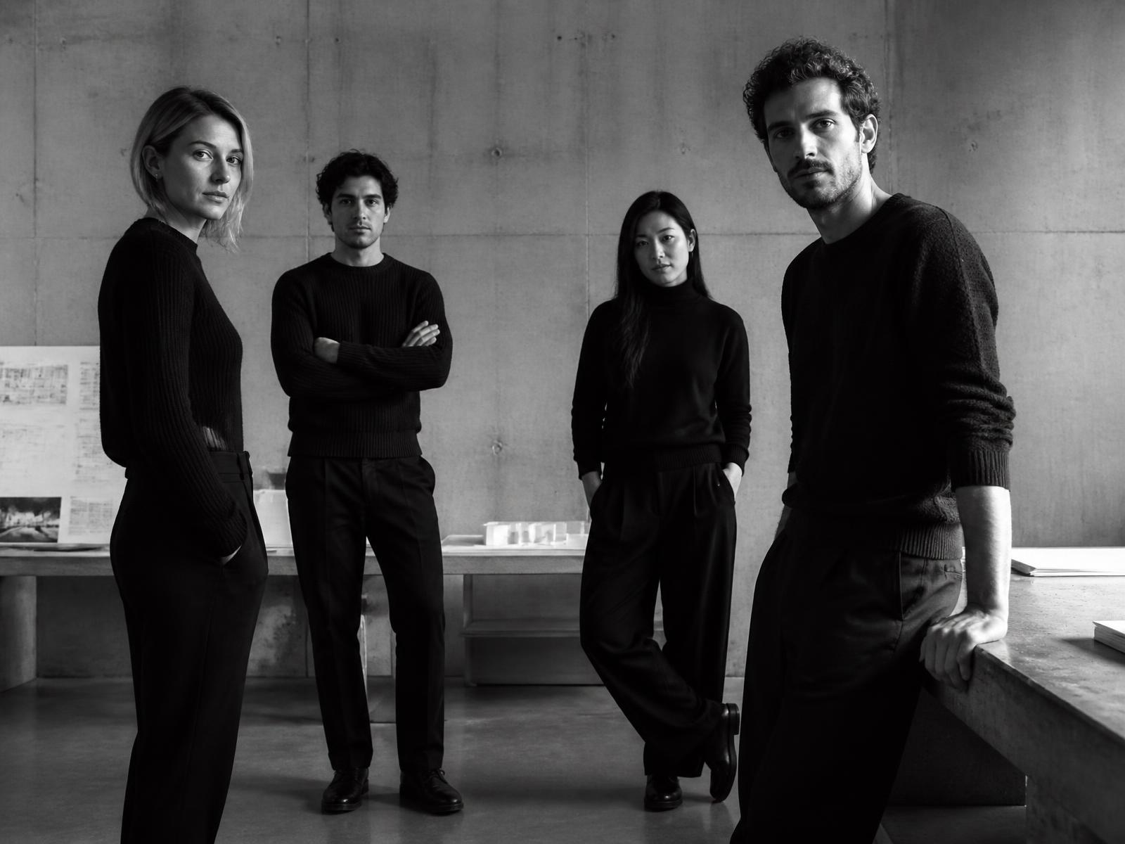 The members of NØR Atelier standing in a bare concrete studio
